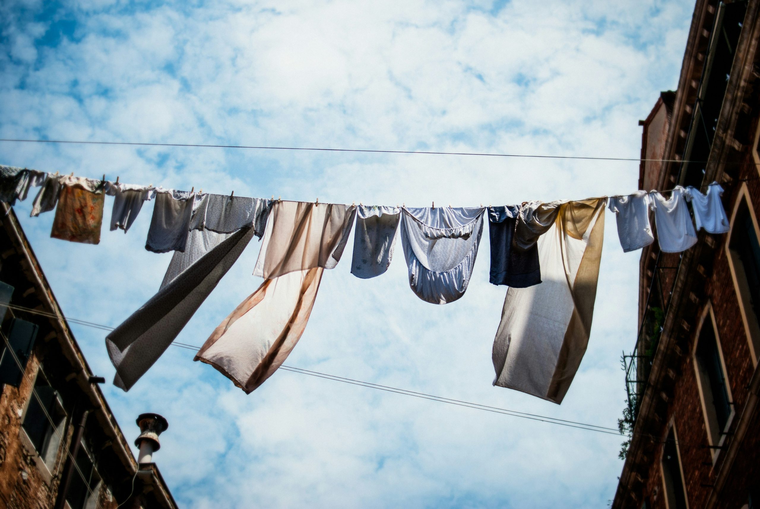 Washing hanging on a line. Photo by Erik Witsoe on Unsplash.com